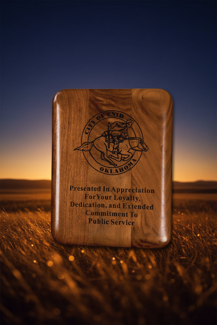 Wooden plaque with engraved text and logo, presented by the City of Enid, Oklahoma.
