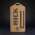 Brown leather key holder with 'RICK' engraving on a white background