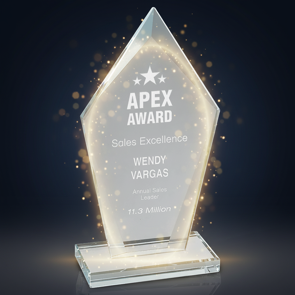 Clear glass award with engraved text on a green background