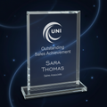 Clear glass award with engraved text and UNI logo on a white background