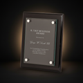 Glass award plaque with engraved text on a white background