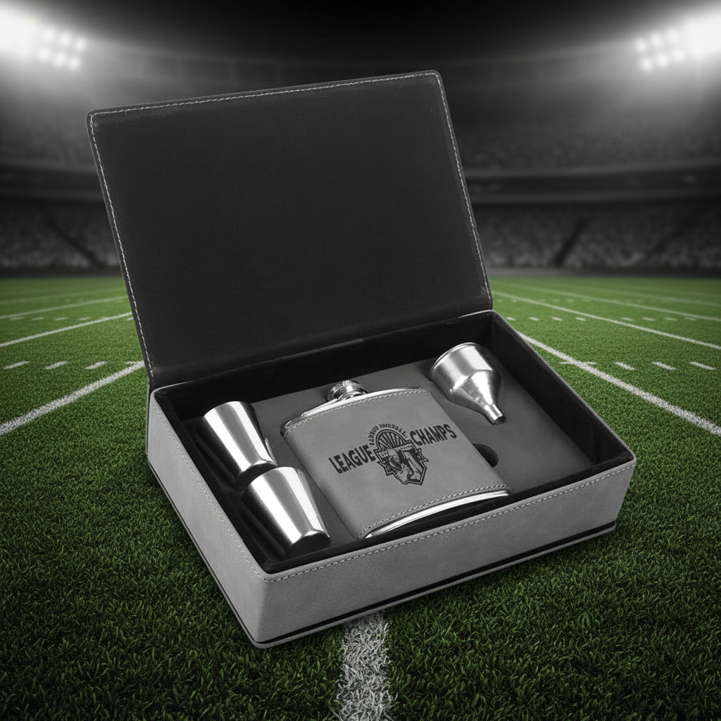 Silver flask set with 'League of Champs' engraving in a black box.