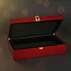 Red jewelry box with a gold clasp on a black background