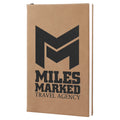 Beige notebook with 'Miles Marked Travel Agency' logo on a white background