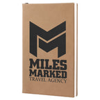 Beige notebook with 'Miles Marked Travel Agency' logo on a white background