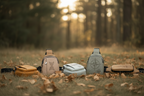 Four bags in different colors on a ground with grass and leaves