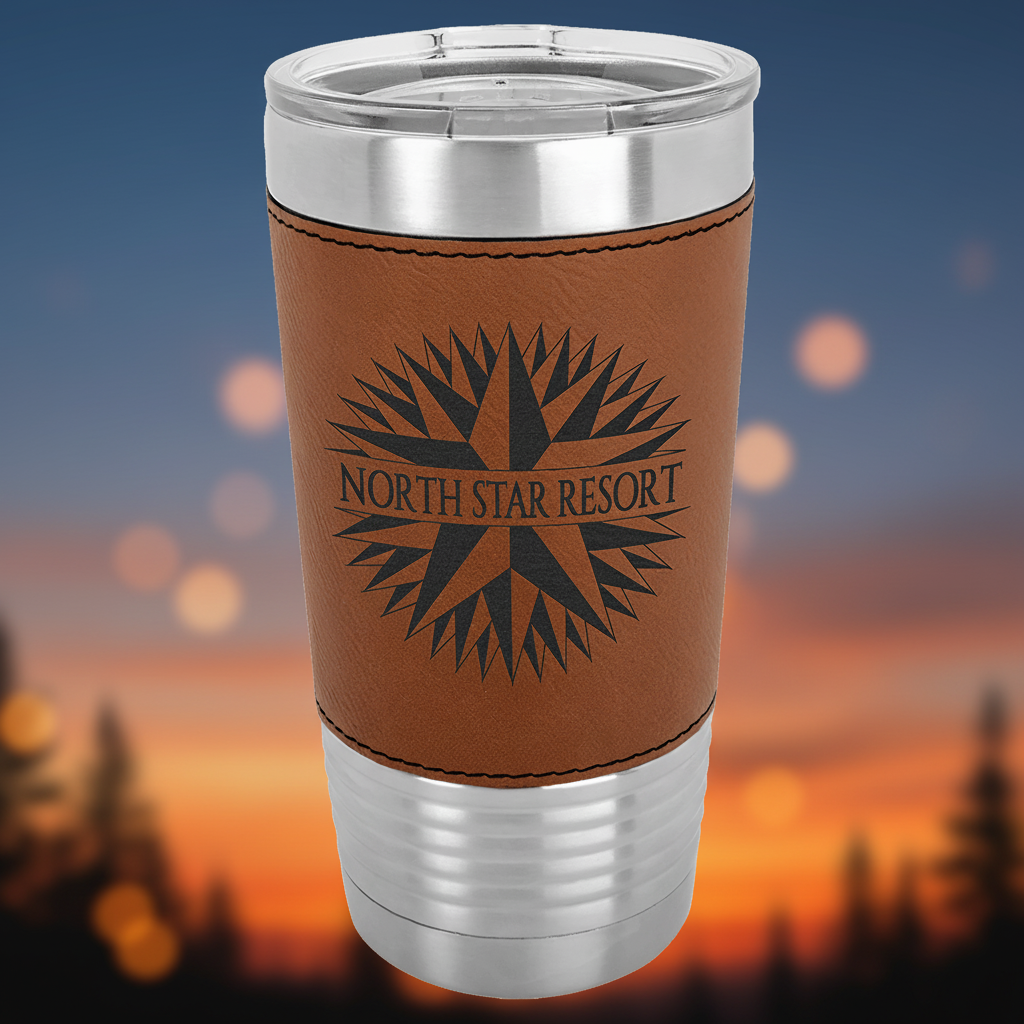 Stainless steel tumbler with brown leather wrap featuring 'North Star Resort' logo on a clear background