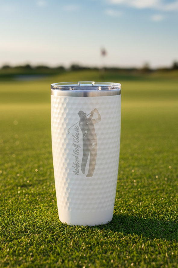 Stainless steel tumbler with golf-themed design on a white background