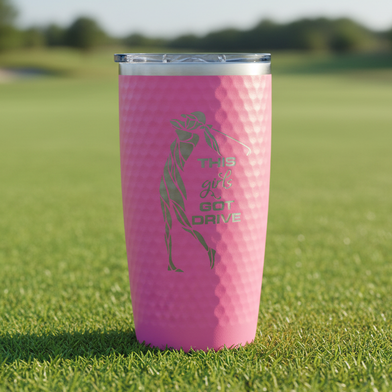 Pink tumbler with golf-themed design and text on a white background