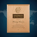 Wooden plaque with 'Salesman of the Year' award text on a gray background