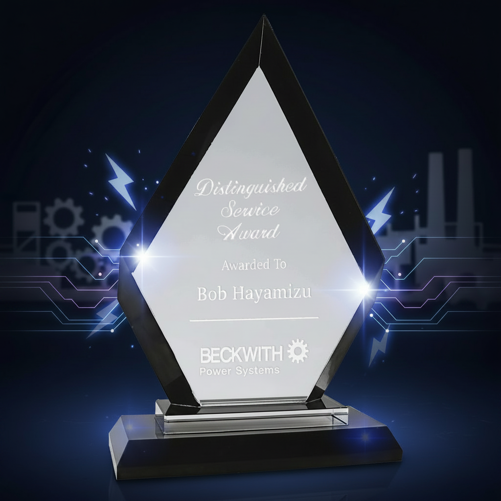 Diamond-shaped glass award with engraved text on a clear background
