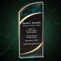 Glass award with engraved text on a clear background