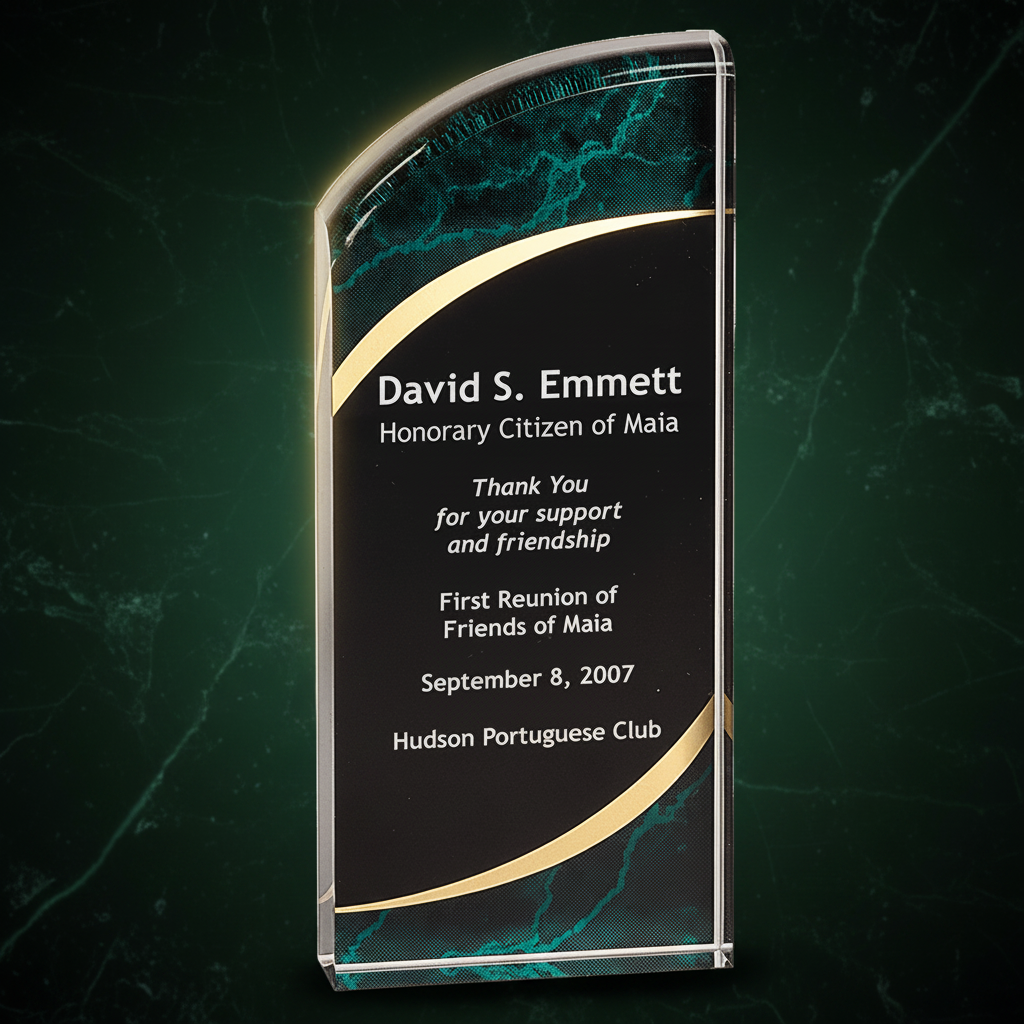 Glass award with engraved text on a clear background