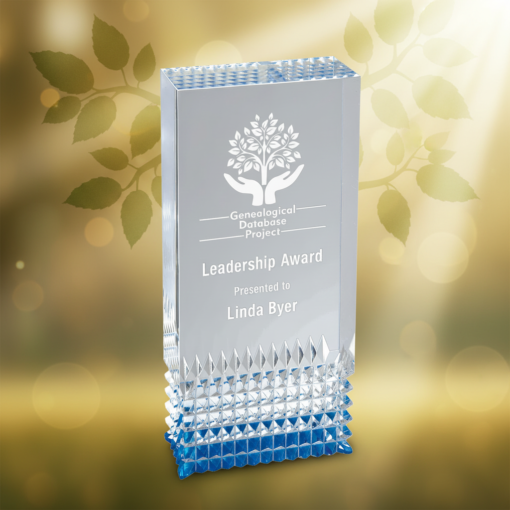 Clear glass award with engraved text on a white background