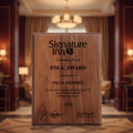 Wooden plaque with engraved text and 'Signature Inn' logo